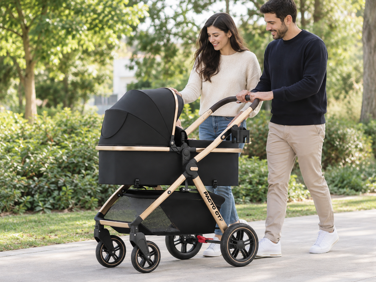 A couple strolling outdoors with a black Pacto CT convertible stroller featuring a gold frame